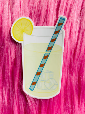 Lemonade sticker with straw and a slice of lemon on the glass. 